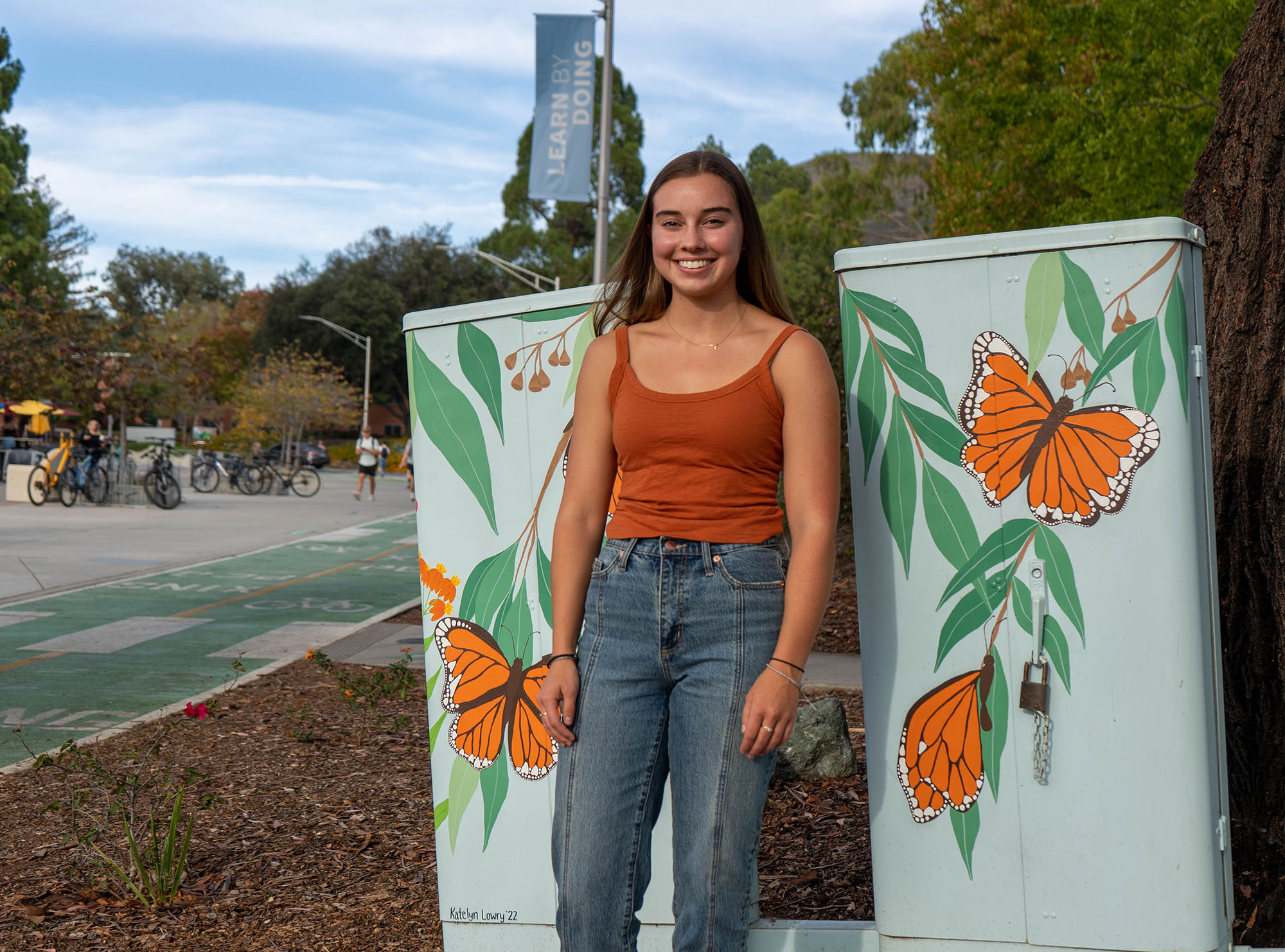 Girl standing next to the utility box