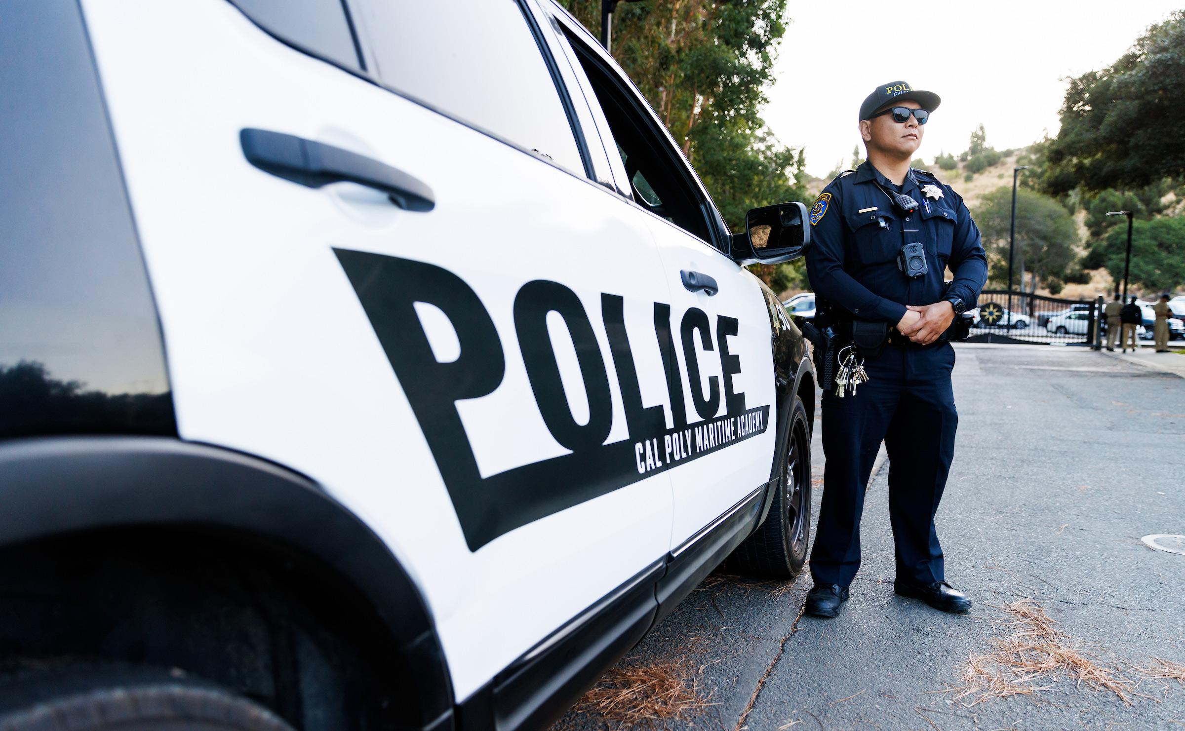 Cal Poly Maritime Academy police officer standing beside a patrol vehicle
