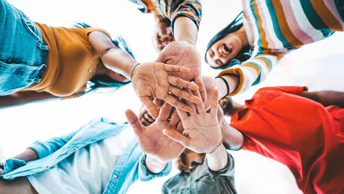 six-people-with-hands-together