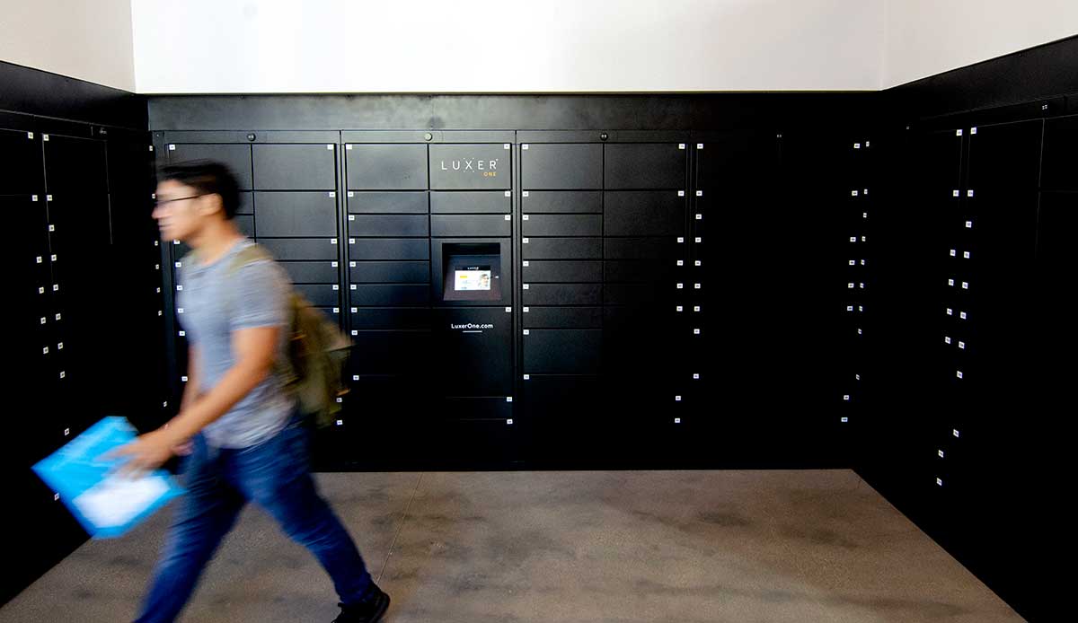 Mail lockers with a student walking by