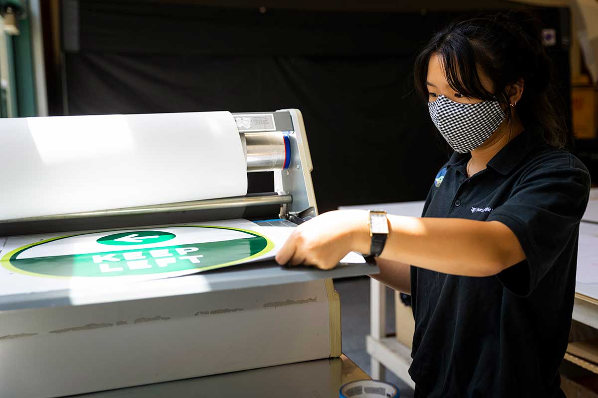 Woman printing signs directional signs