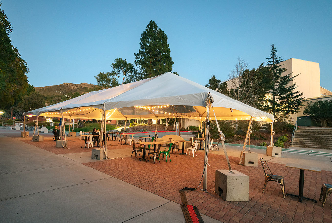 Large tent with lights and tables setup outside