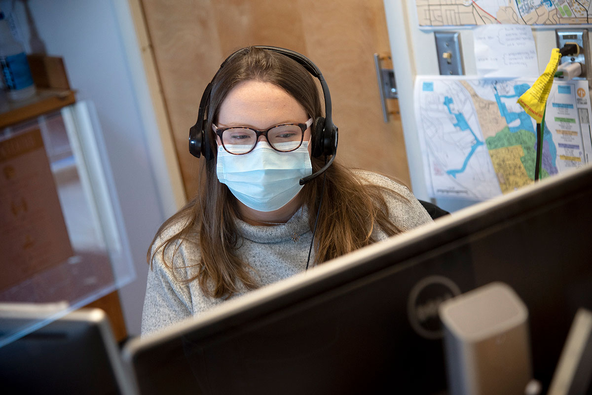 Staff member wearing a mask at her desk